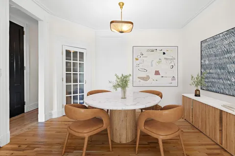 a dining room with furniture and window