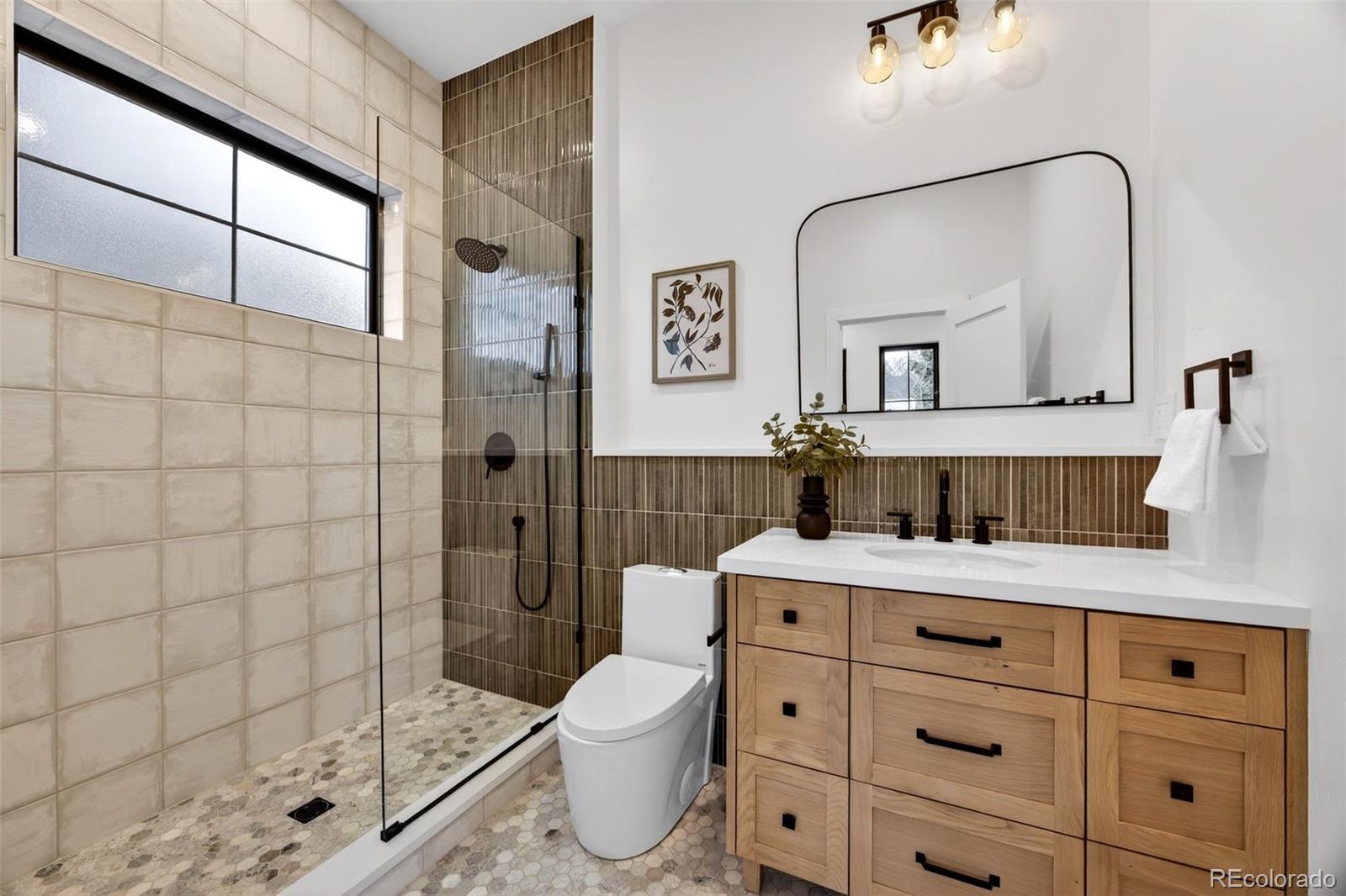 5175 Raleigh Street Denver, CO 80212 - Photo 14 of 49 a bathroom with a granite countertop sink a toilet and shower