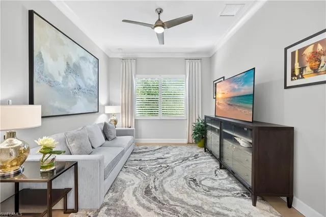 a living room with furniture and flowers
