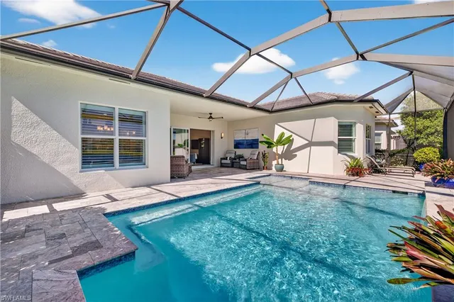 a view of a swimming pool with outdoor seating