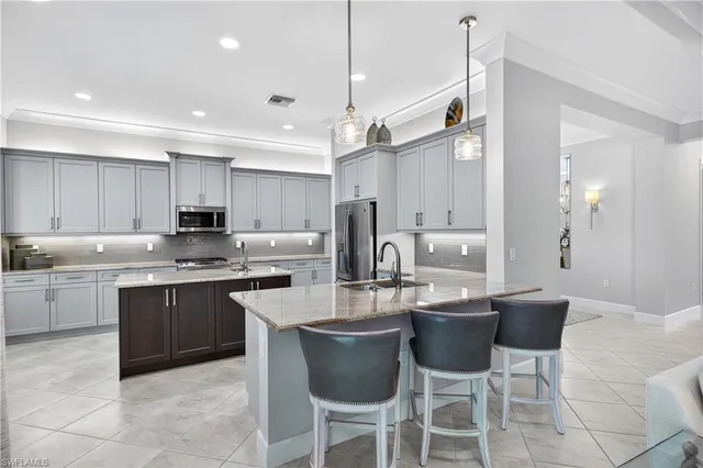 a kitchen with sink cabinets and living room view