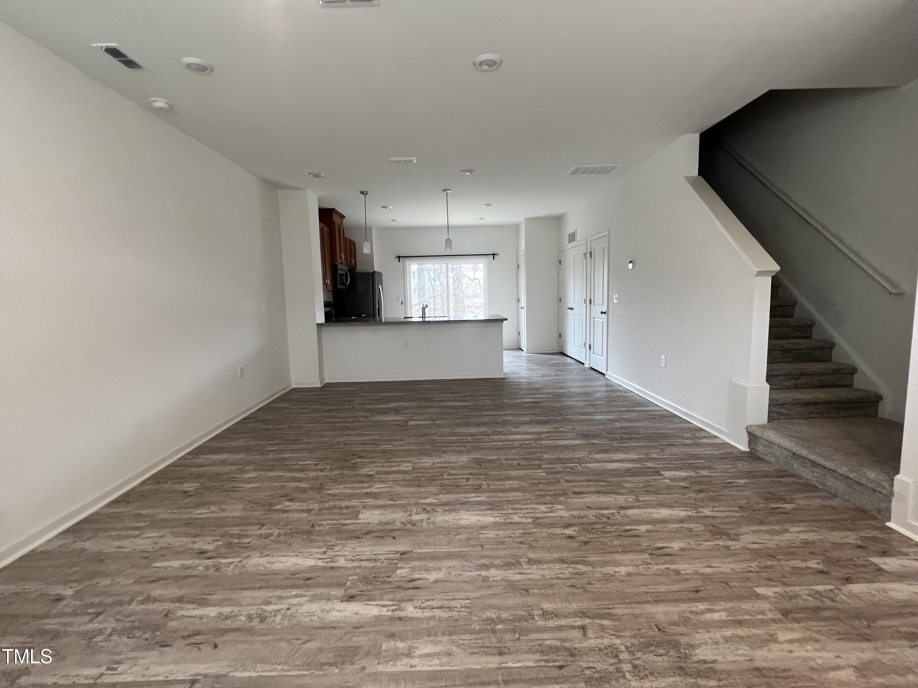 3118 Crater Loop Raleigh, NC 27610 - Photo 2 of 14 a view of a room with wooden floor and stairs
