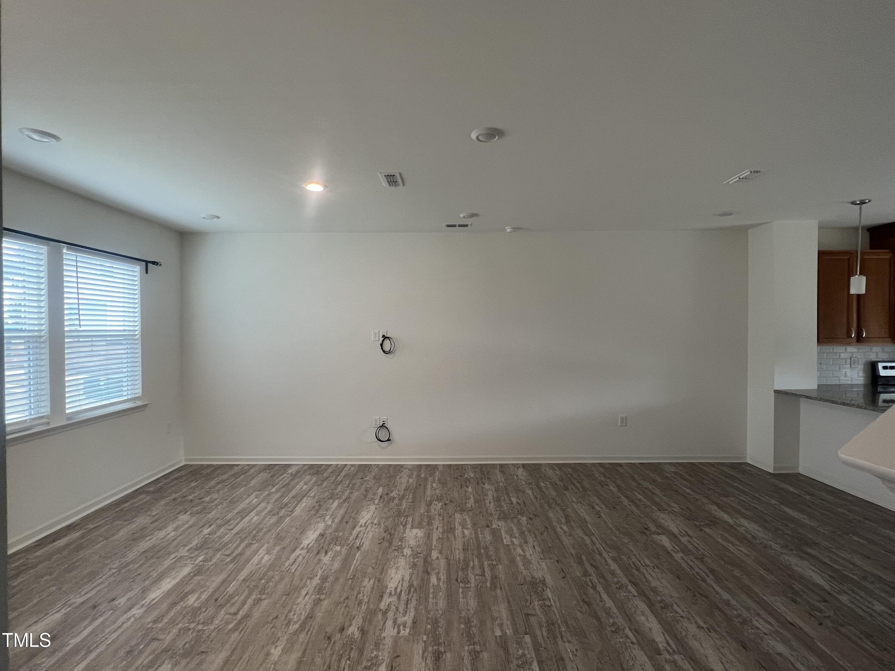 3118 Crater Loop Raleigh, NC 27610 - Photo 3 of 14 an empty room with wooden floor and windows