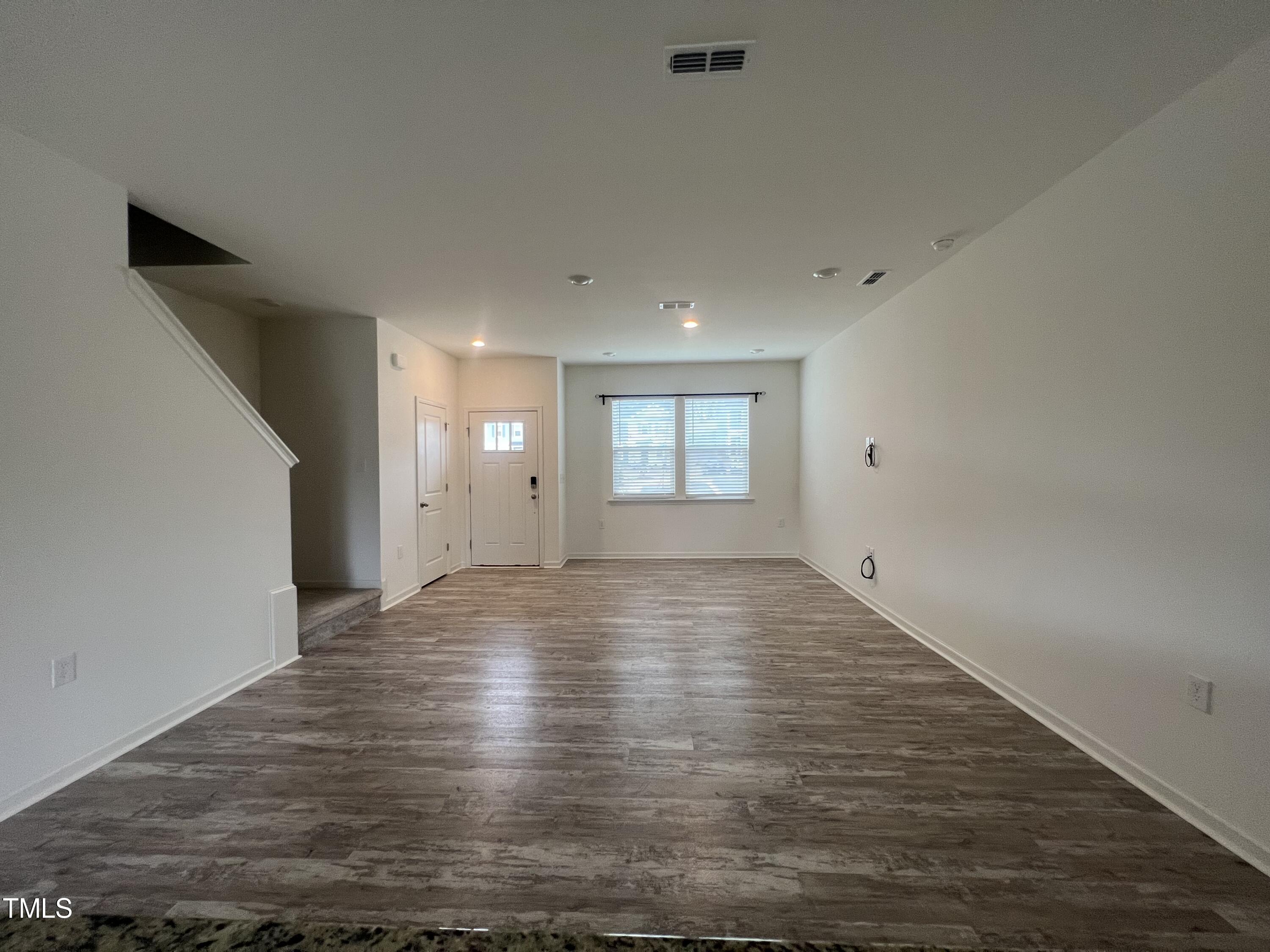 3118 Crater Loop Raleigh, NC 27610 - Photo 4 of 14 a view of empty room with window and wooden floor