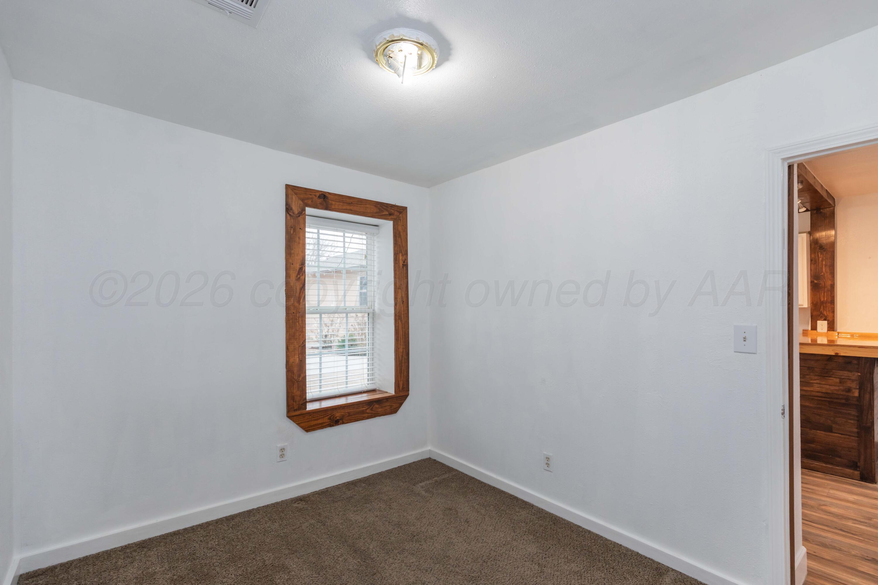 1503 7th Avenue Canyon, TX 79015 - Photo 19 of 30 an empty room with windows and closet