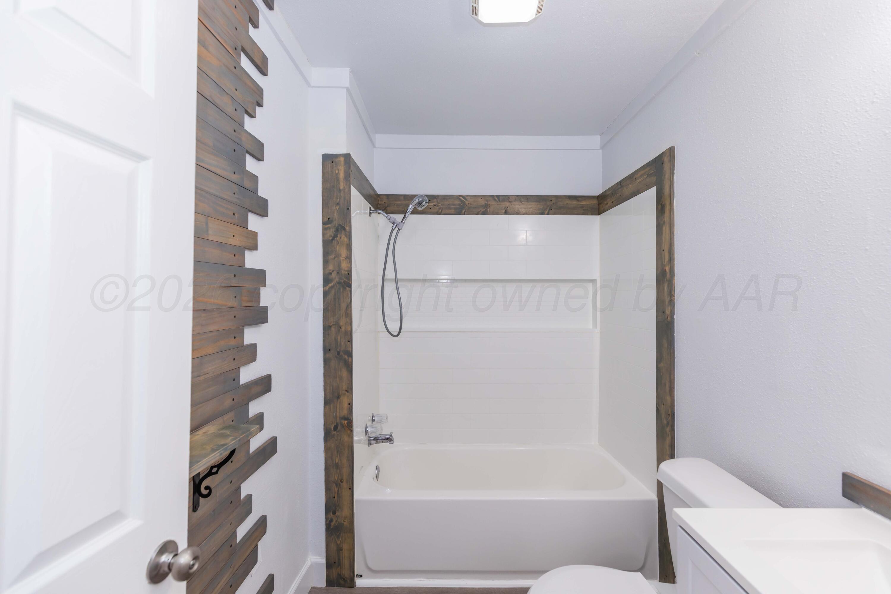 1503 7th Avenue Canyon, TX 79015 - Photo 22 of 30 a bathroom with a bathtub and a shower