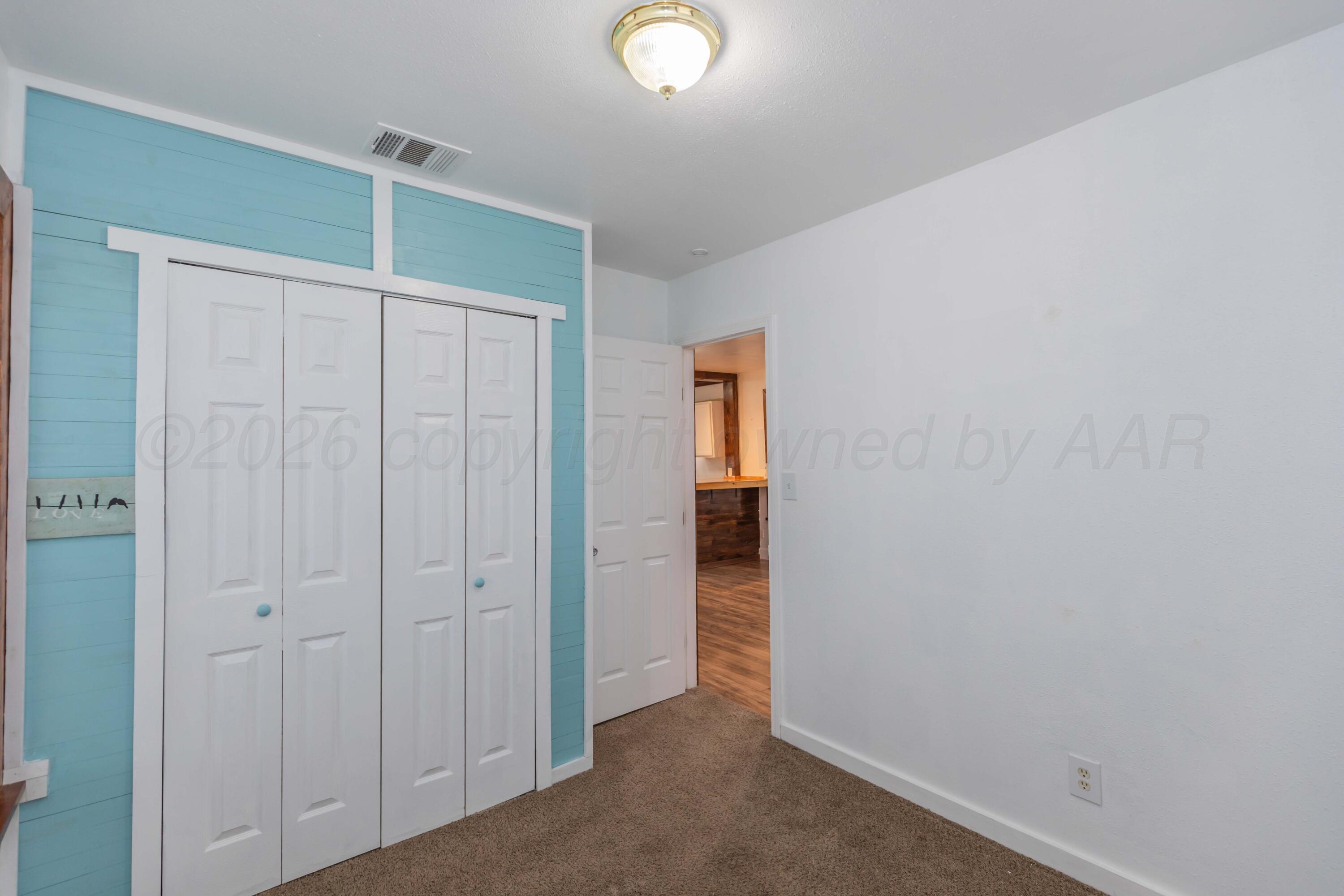 1503 7th Avenue Canyon, TX 79015 - Photo 25 of 30 a view of an empty room with closet area