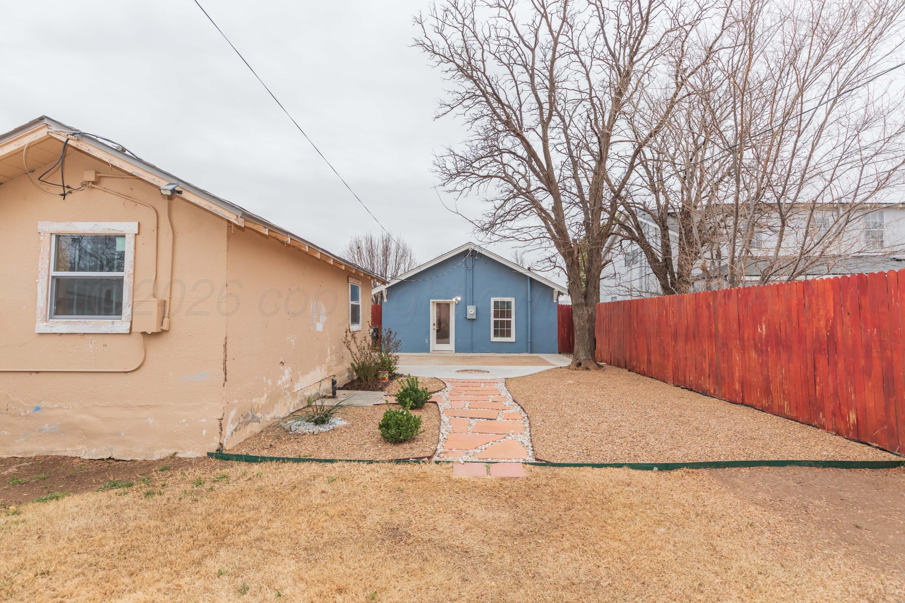 1503 7th Avenue Canyon, TX 79015 - Photo 26 of 30 a view of a house with a yard covered in snow