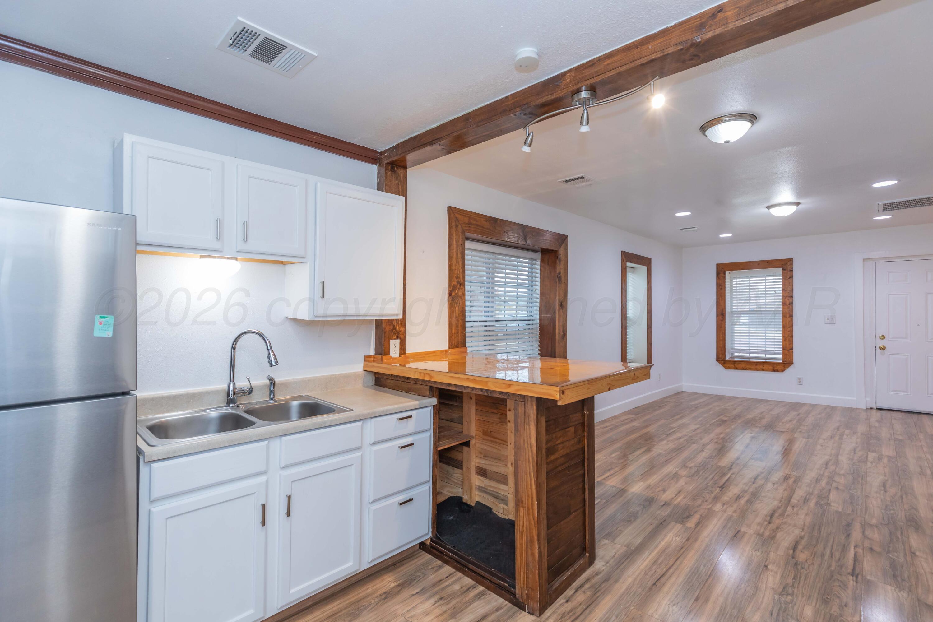 1503 7th Avenue Canyon, TX 79015 - Photo 3 of 30 a kitchen with kitchen island a sink appliances and cabinets