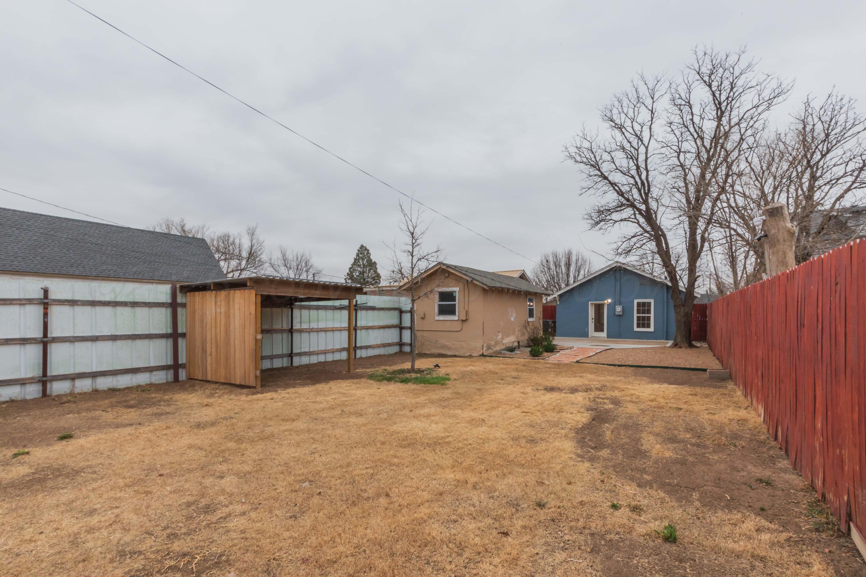 1503 7th Avenue Canyon, TX 79015 - Photo 7 of 30 a view of a house with a yard and large tree