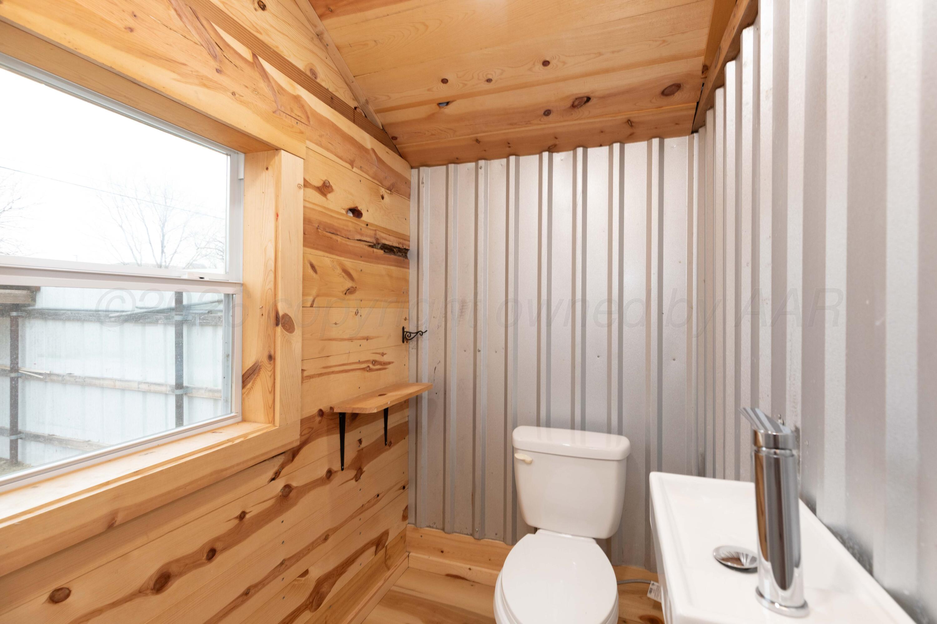 1503 7th Avenue Canyon, TX 79015 - Photo 9 of 30 a bathroom with a toilet a sink and a shower curtain