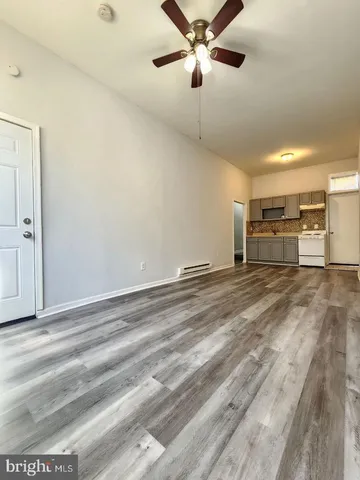 wooden floor in an empty room with a chandelier