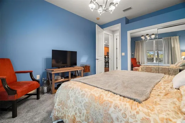 a bedroom with furniture and a flat screen tv