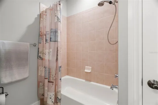 a bathroom with a bath tub and shower