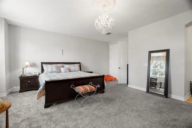 a bed room with a bed and a chandelier