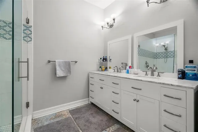 a bathroom with a sink vanity and mirror