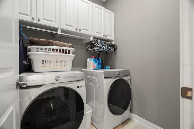 a view of washer and dryer with kitchen in the background
