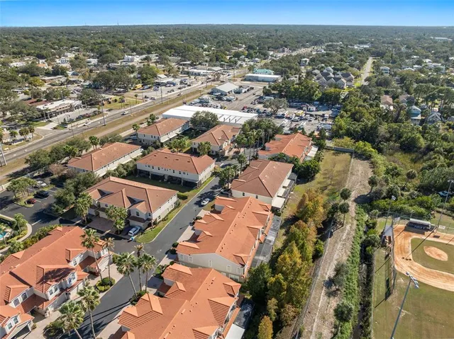 an aerial view of residential houses with city view