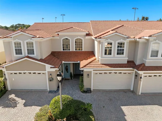 a white house covered with tall trees