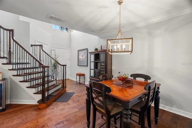 a dining room with furniture a rug and wooden floor