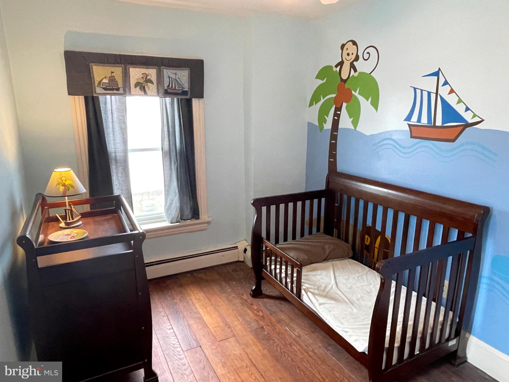 245 Maple Street Oxford, PA 19363 - Photo 11 of 23 a bedroom with a bed and wooden floor