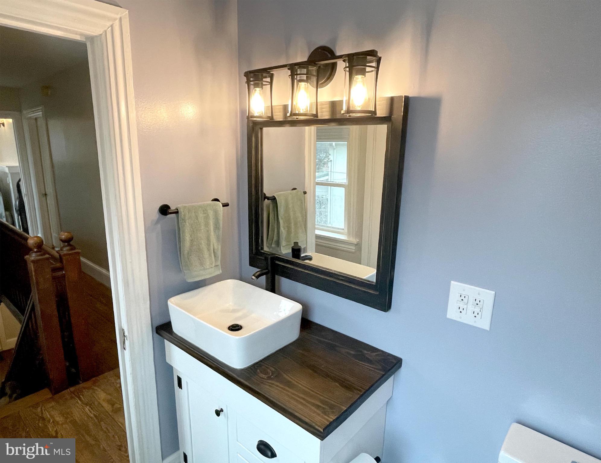 245 Maple Street Oxford, PA 19363 - Photo 14 of 23 a bathroom with a sink a mirror and a shower