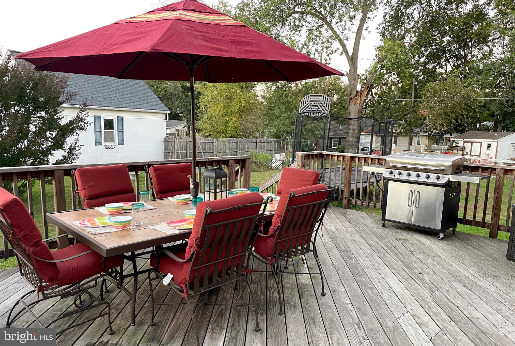 245 Maple Street Oxford, PA 19363 - Photo 22 of 23 a patio with a table and chairs under an umbrella