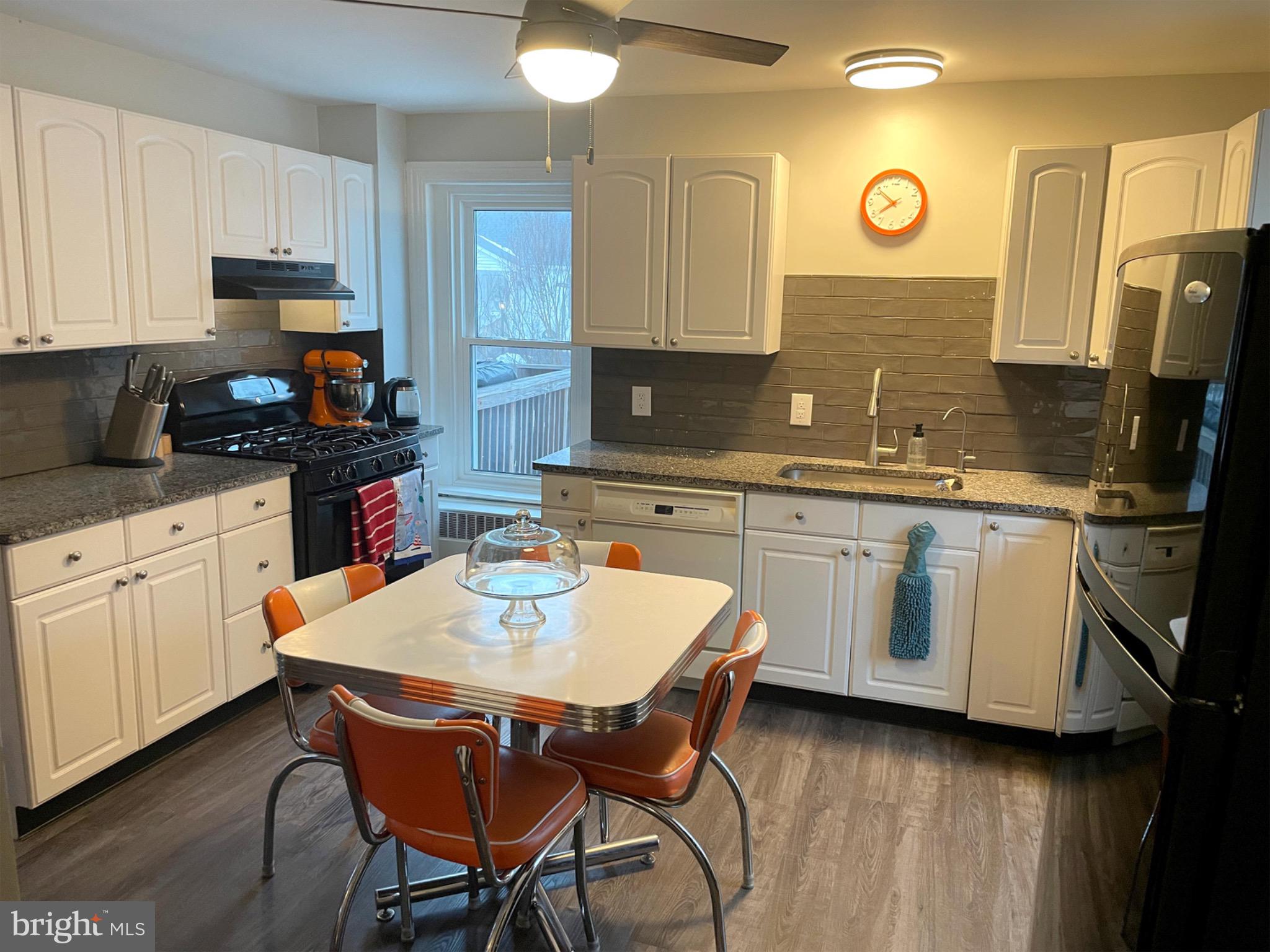 245 Maple Street Oxford, PA 19363 - Photo 6 of 23 a kitchen with a sink cabinets and wooden floor