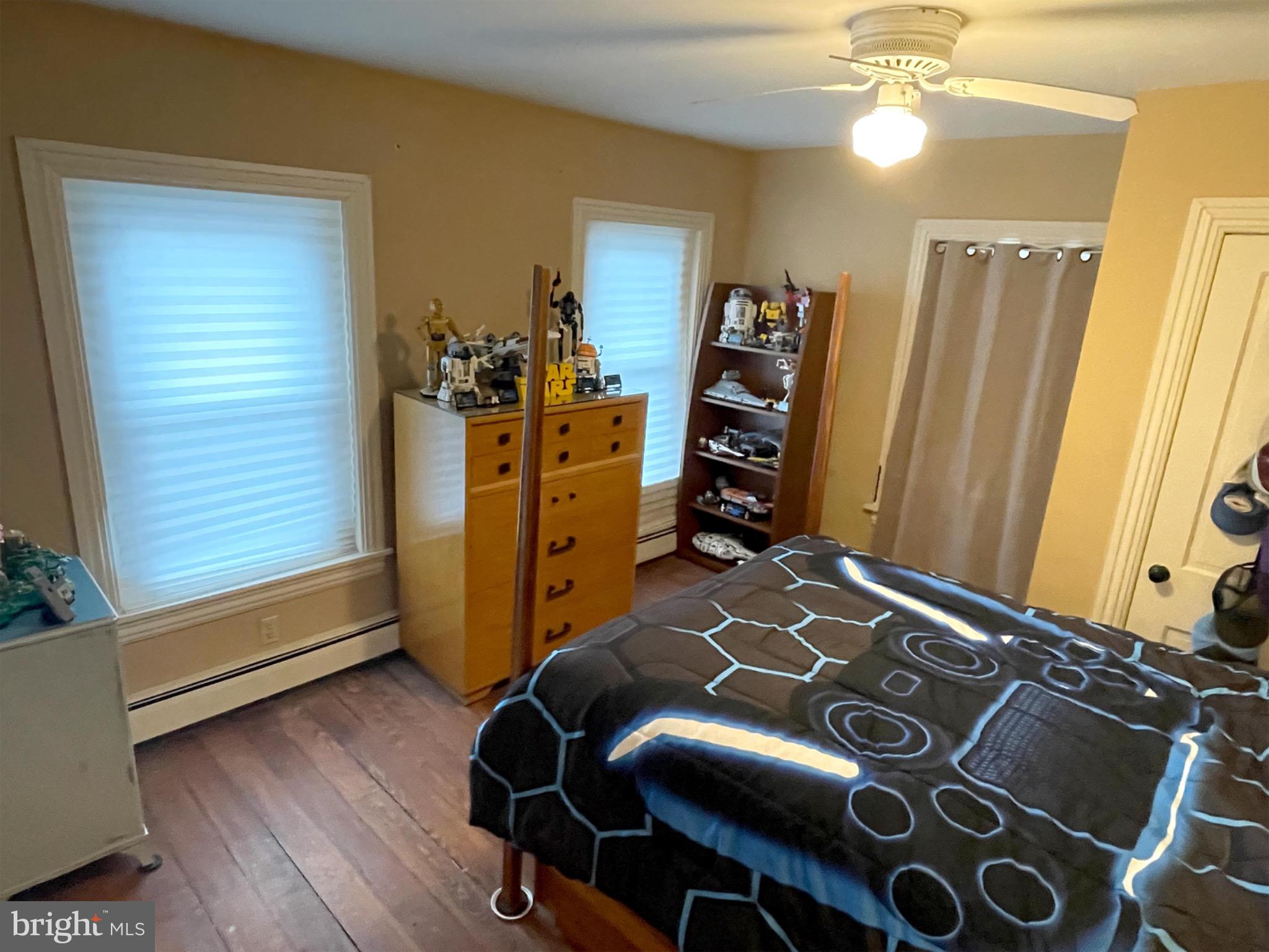 245 Maple Street Oxford, PA 19363 - Photo 9 of 23 a bedroom with a bed and wooden floor