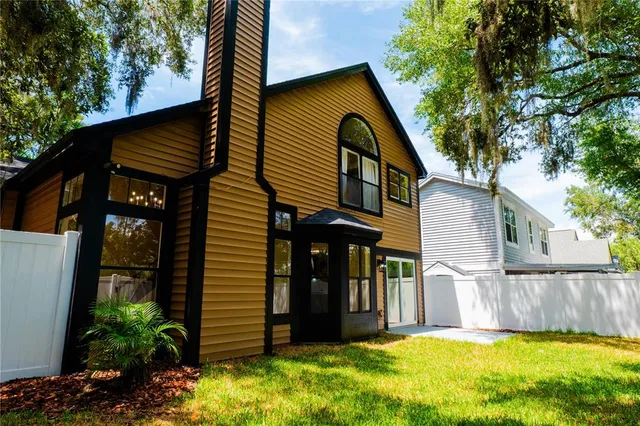 a view of a house with a yard and furniture