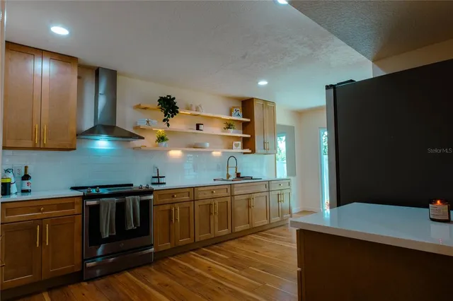 a kitchen with stainless steel appliances granite countertop a sink and cabinets