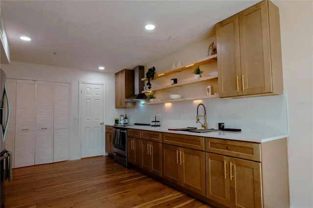 a kitchen with stainless steel appliances granite countertop a sink and cabinets