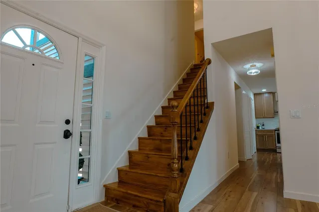 a view of entryway with wooden floor and stairs