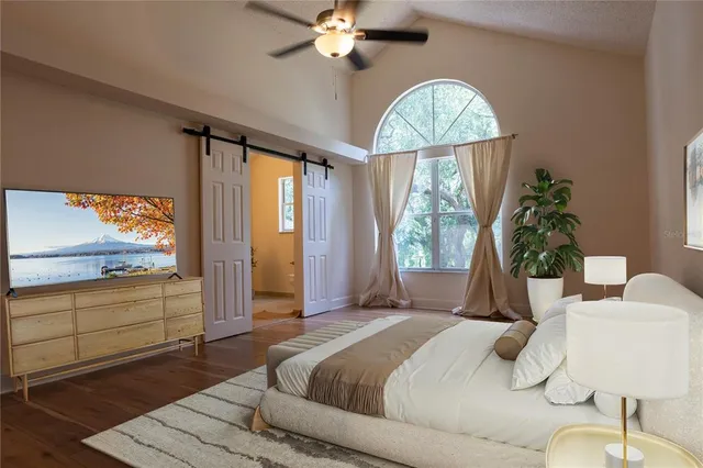 a bedroom with a large bed and a window