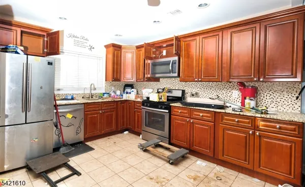 a view of living room kitchen with furniture and wooden floor