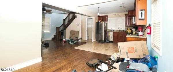 a living room with furniture hard wood floor and a chandelier