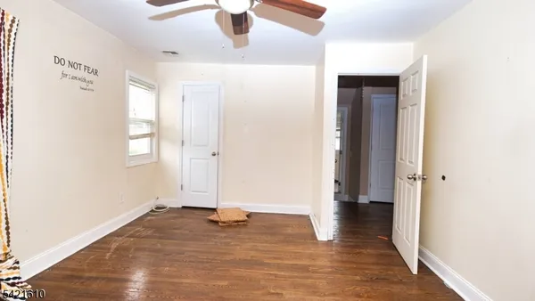 a view of a room with wooden floor and window