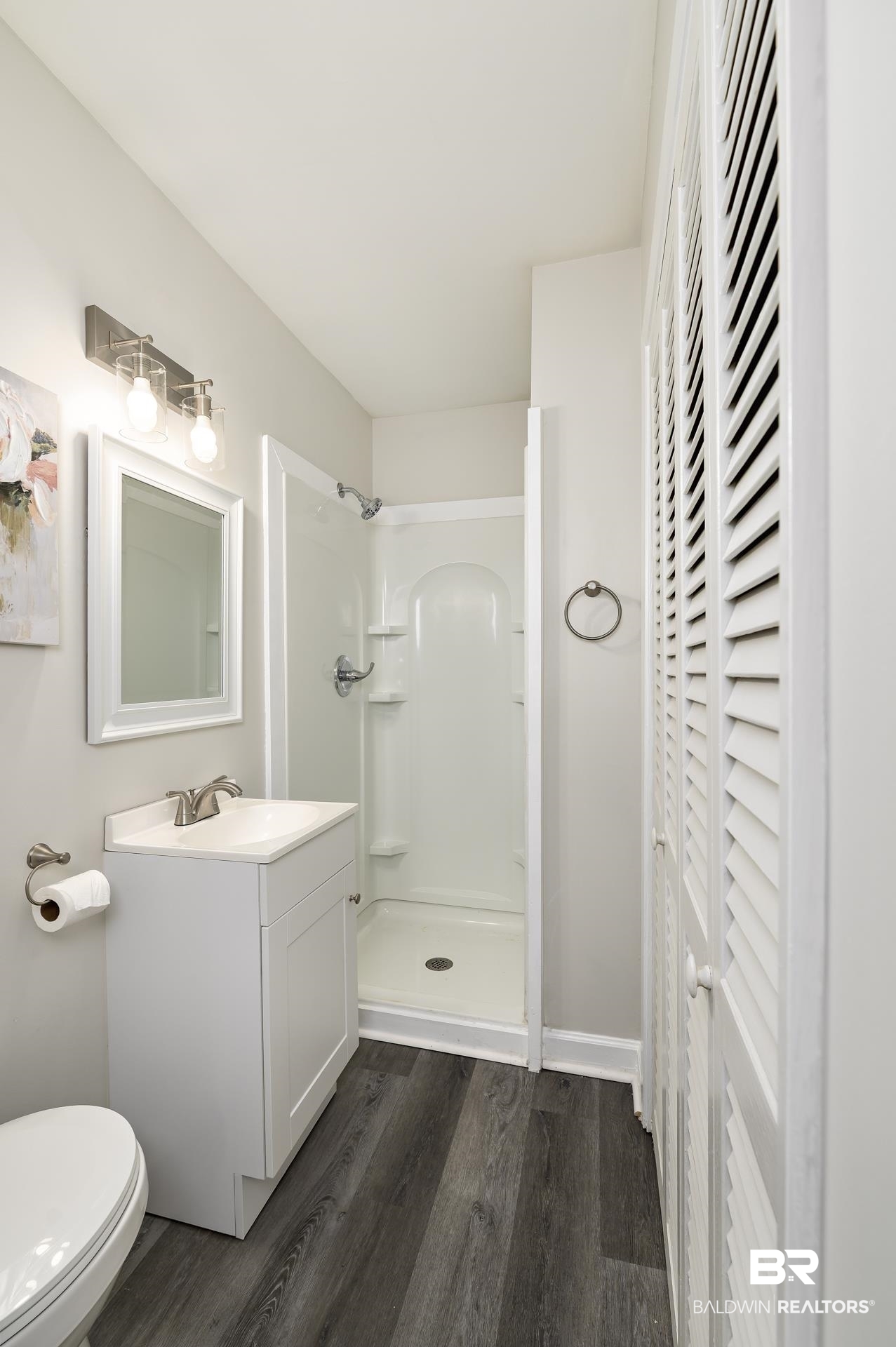 5922 Sunnyside Drive Mobile, AL 36619 - Photo 24 of 51 Full bathroom featuring a stall shower, wood finished floors, vanity, and toilet