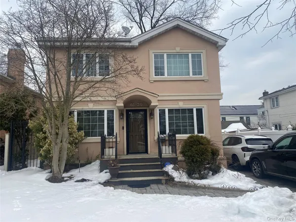 a front view of a house with a yard outdoor seating and garage