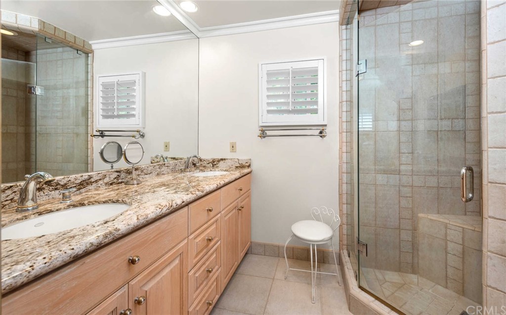 3381 Colbert Avenue Mar Vista, CA 90066 - Photo 14 of 23 a bathroom with a granite countertop sink a toilet a mirror and shower