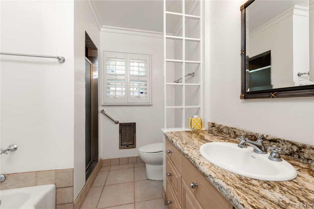 3381 Colbert Avenue Mar Vista, CA 90066 - Photo 17 of 23 a bathroom with a granite countertop sink a mirror and a toilet