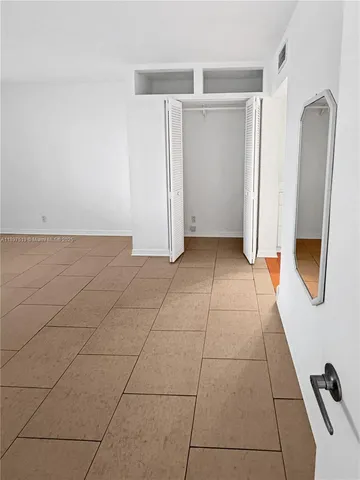 a view of a livingroom with an empty space and a window