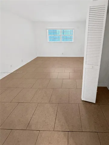 an empty room with wooden floor