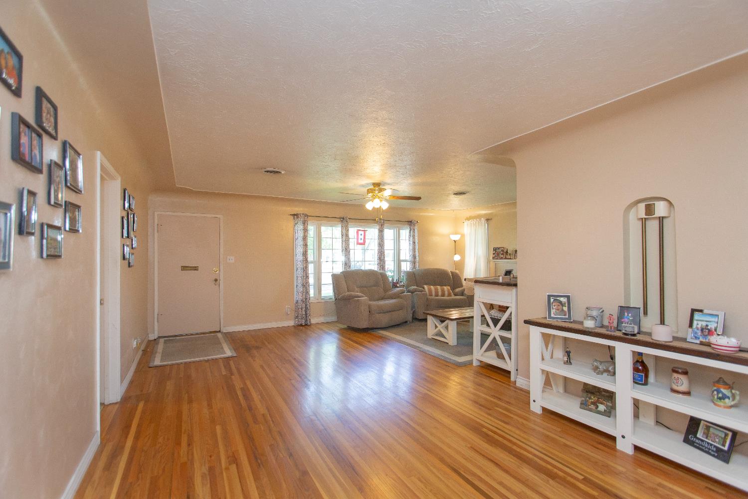 401 Fortuna Avenue Modesto, CA 95354 - Photo 12 of 43 a view of living room filled with furniture and wooden floor