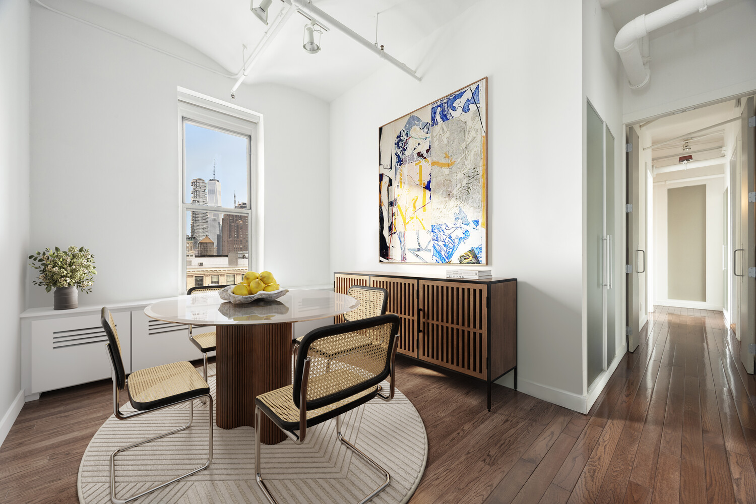 543 Broadway, Unit PH Manhattan, NY 10012 - Photo 5 of 14 a view of a dining room with furniture and wooden floor