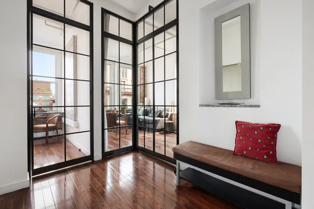 a bedroom with a bed and windows