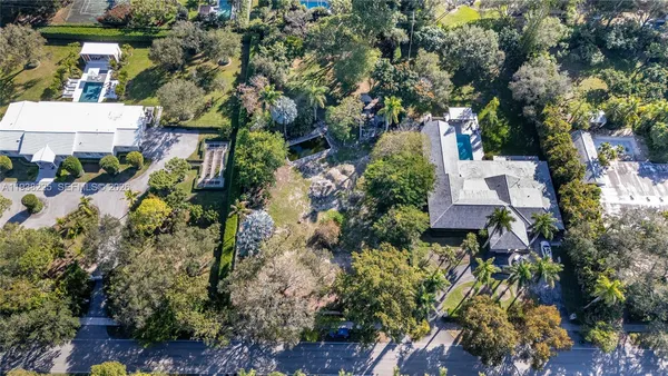 an aerial view of a house with a yard and garden