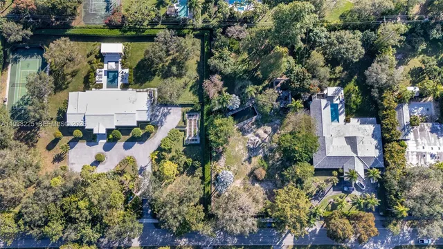 an aerial view of a house with a yard and garden