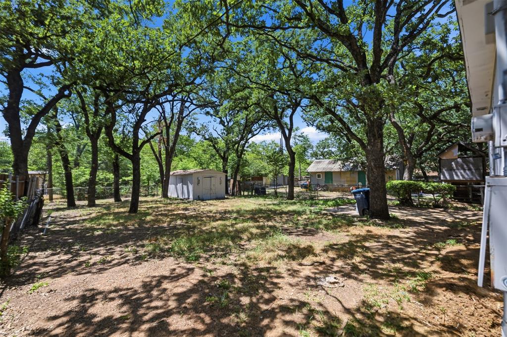 3308 Rufus Street Fort Worth, TX 76119 - Photo 16 of 17 Expansive rear yard featuring numerous mature trees providing ample shade