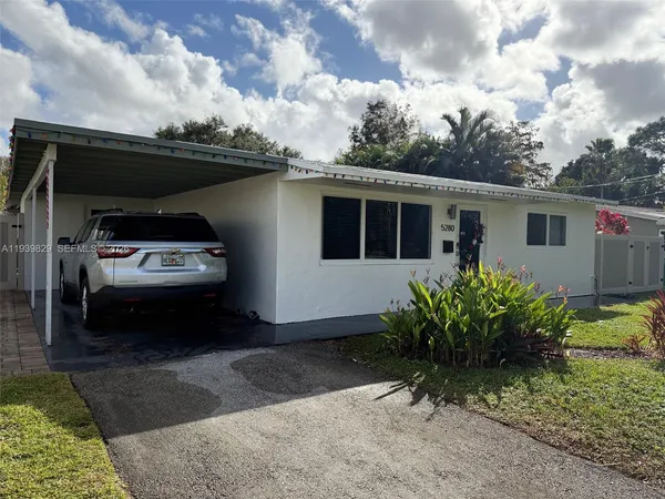 a front view of house with a garden